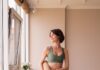 집에서도 간편하게, ‘필라테스’로 건강 챙기기… 일상 속 실천법은? a woman in a green sports bra top and leggings holding a yoga mat