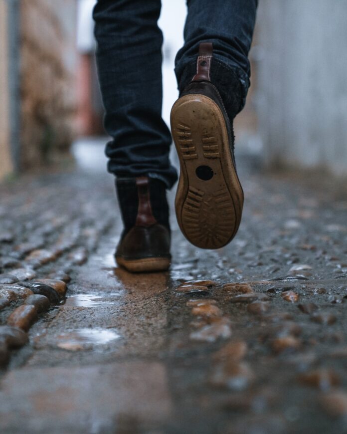 Photo by Alejandro Luengo close-up photography of person walking on pavement
